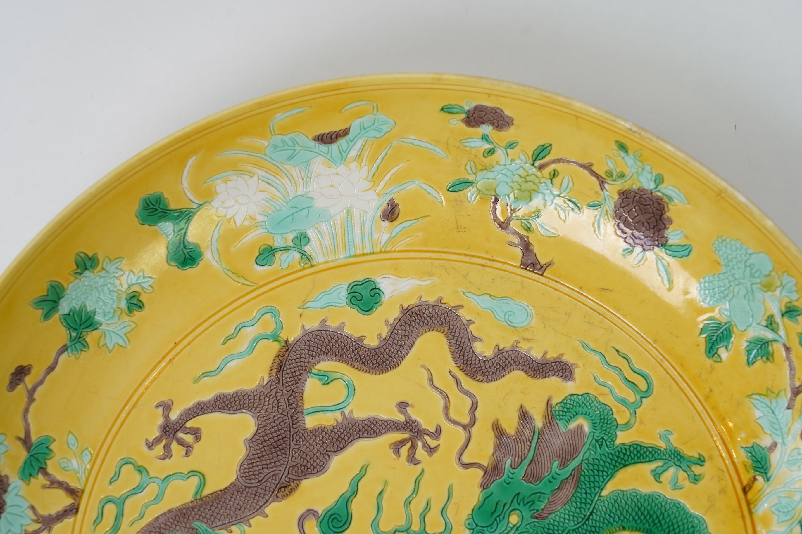A Chinese yellow, green and aubergine glazed and incised ‘dragon’ dish, chuxiugong zhi hall mark, possibly Guangxu period